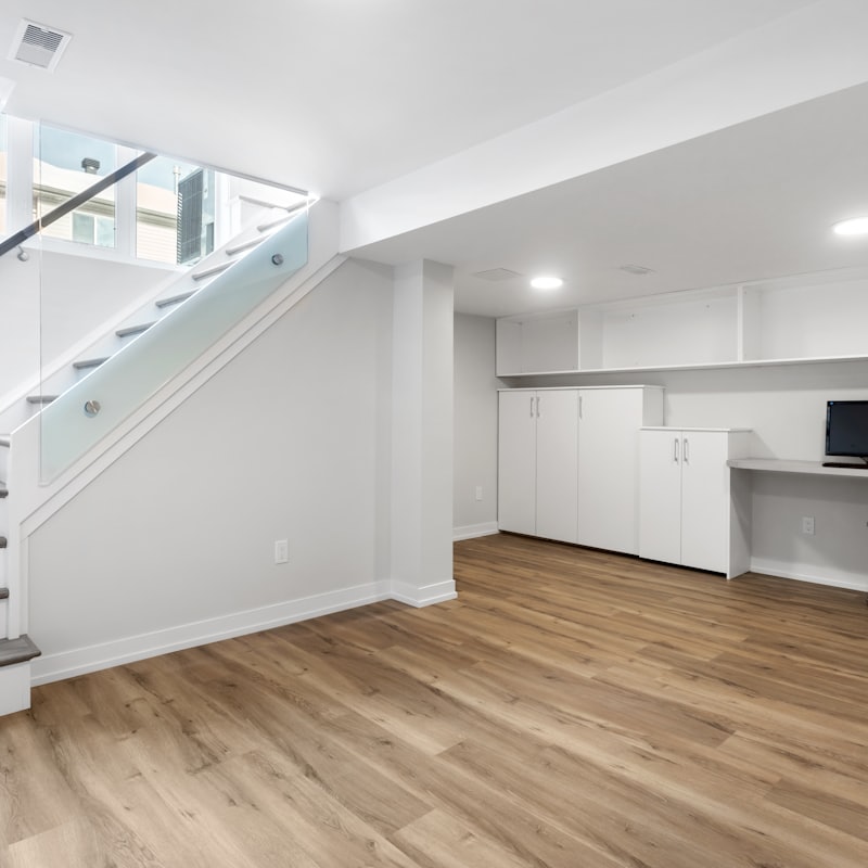 Bright basement conversion in a London home with staircase and home office